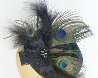 May include: A black velvet hat with a black bow and peacock feathers. The feathers are green, blue, and brown.