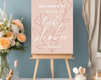 May include: A pink welcome sign with a floral design and the text "Welcome to the Bunthuwong's Baby Shower September 2023".