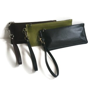 May include: Three leather wristlets in brown, green, and black with matching wrist straps.