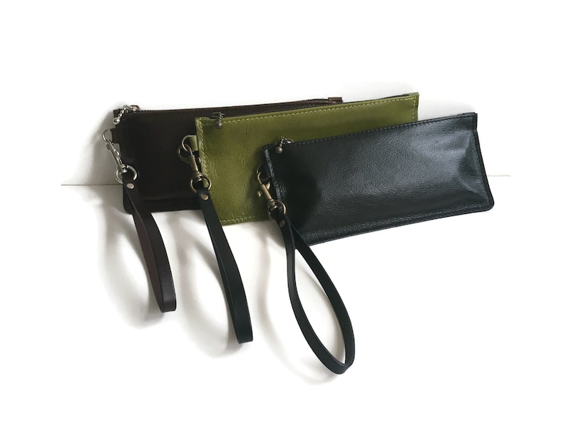 May include: Three leather wristlets in brown, green, and black with matching wrist straps.
