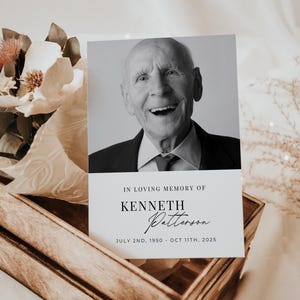 May include: A black and white photograph of a man smiling, with the text "In loving memory of Kenneth Patterson July 2nd, 1950 - Oct 11th, 2025" printed below the image.