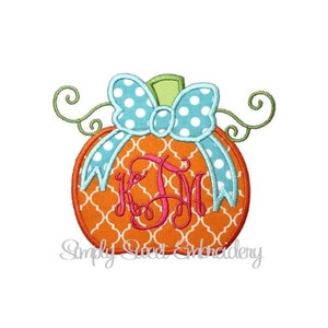 May include: Orange pumpkin with a blue and white polka dot bow and a pink monogram "KSM" on a white background.
