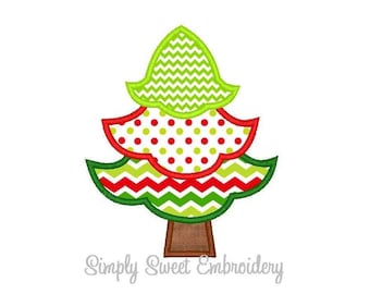May include: A green, red, and white Christmas tree with a brown trunk. The tree is decorated with a chevron pattern, polka dots, and a solid green top.