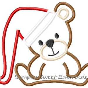 May include: A brown teddy bear wearing a red and white Santa hat. The bear is sitting with its legs crossed and has a happy expression on its face.