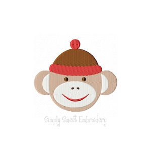 May include: Embroidered design of a monkey wearing a red and brown hat. The monkey has a white face with brown eyes and a red smile.