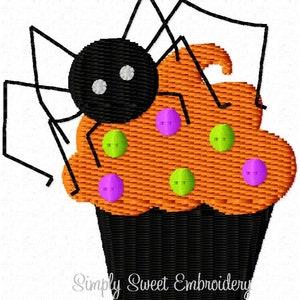 May include: A black spider sits on top of an orange cupcake with green and purple sprinkles. The cupcake has a black frosting base.