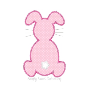 May include: Pink bunny applique with white polka dots and a white star on the back. The bunny has pink ears and a pink outline.