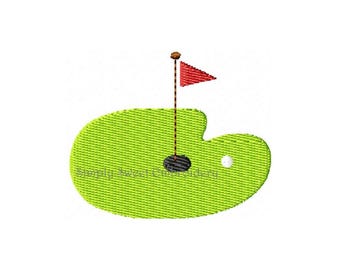 May include: A green golf putting green with a red flag, a black hole, and a white golf ball.