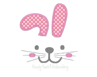 May include: Embroidered bunny face design with pink ears with white polka dots, a gray nose, and pink cheeks. The design includes a gray mouth with whiskers.