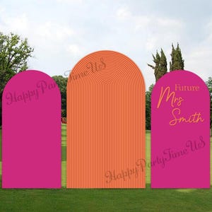 May include: Three arched backdrop panels standing in a row. The two outer panels are solid magenta, while the center panel is orange with a vertical ribbed texture. The right panel features the orange text Future Mrs Smith in cursive script.