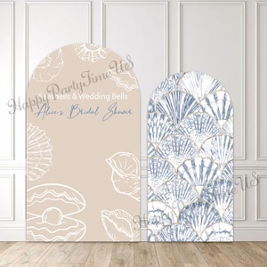 May include: Two arched backdrop panels with a beach theme. One panel is tan with seashell illustrations and text that reads "Happy Party Time Us" and "Alice's Bridal Shower." The other panel has a blue and white seashell pattern.