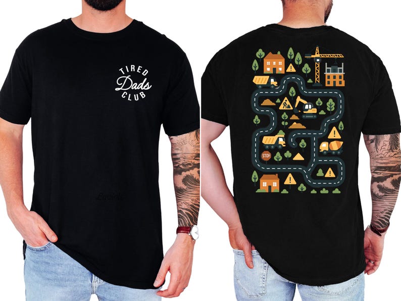 May include: Black crew neck t-shirt with the text "Tired Dads Club" in a white, circular design on the front. The back features a colorful construction site graphic with roads, houses, and construction vehicles.