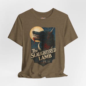 May include: Brown t-shirt featuring a graphic of a snarling wolf with a long red tongue, set against a full moon and a blue background. The text "The Slaughtered Lamb PUB" is below the wolf image.