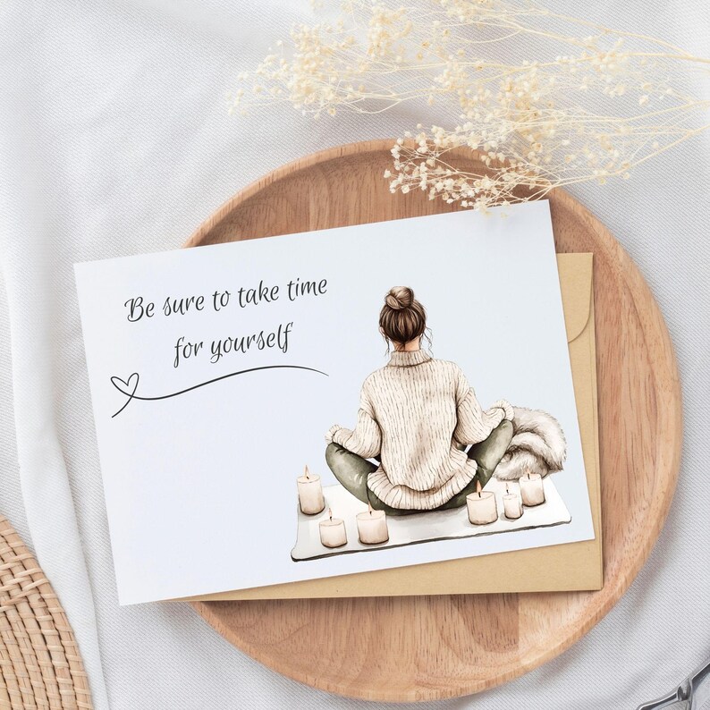 Mockup of greeting card with woman meditating on front. Verbiage says, Be sure to take time for yourself.