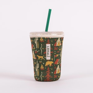 May include: A green reusable cup with a camping-themed design featuring a bear, a dog, a tent, and a campfire. The cup has a white lid and a green straw. The text "LOHALLI" is printed on the cup.