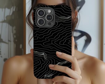 May include: A black phone case with a white abstract pattern. The case has a camera lens cutout.