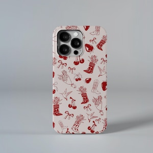 Op de afbeelding: Telefoonhoesje met een herhalend patroon van rode cowboylaarzen, kersen, strikken, aardbeien en kolibries op een lichtbeige achtergrond. De hoes heeft een camera-uitsparing.