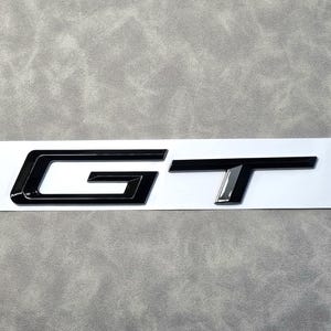 GT Emblem - 2 Adesivi Metallici Per Auto, Logo Portellone Posteriore, Decorazione Auto Argento, 7,3x1,8 Cm