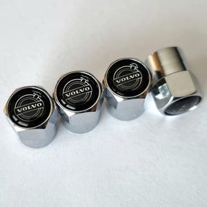 May include: Set of four chrome valve stem caps with a black Volvo logo.