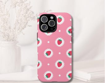 May include: Pink phone case with a repeating pattern of strawberries in white lace circles and white polka dots. The case has a glossy finish and a camera cutout.