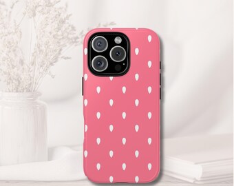 May include: A pink phone case with a strawberry pattern. The case features a repeating pattern of white teardrop shapes against a pink background. The phone case has a black camera module.
