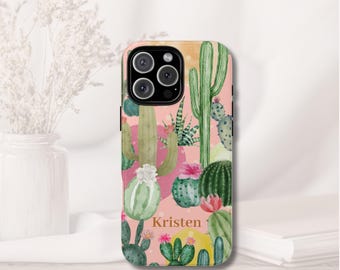 May include: A phone case featuring a watercolor design of various cacti in shades of green, pink, and yellow. The name "Kristen" is printed on the case. The case has a glossy finish and a camera cutout.