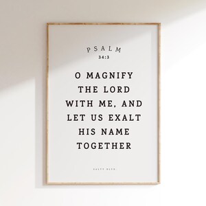 May include: A framed print with a white background and black text. The text reads "PSALM 34:3 O MAGNIFY THE LORD WITH ME, AND LET US EXALT HIS NAME TOGETHER SALTY BLVD."