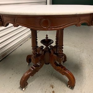 Antique Victorian marble top parlor table highly carved base 25d34.5w29.5h Shipping is not free