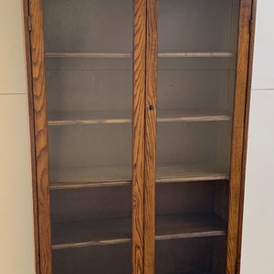 Antique mission oak 2 door bookcase beveled oval mirror 36w60.5h70h11d Shipping is not free