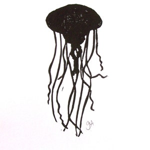 May include: Black ink illustration of a jellyfish on white paper. The jellyfish has a rounded bell shape with long, flowing tentacles. The artwork is a simple, yet striking, depiction of marine life.