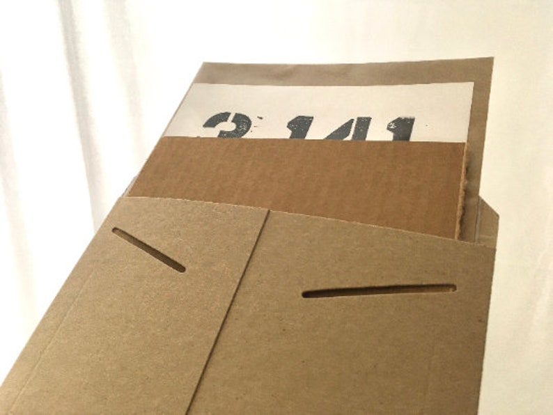 May include: A brown cardboard envelope with a white paper insert. The insert has the number "2141" printed on it.