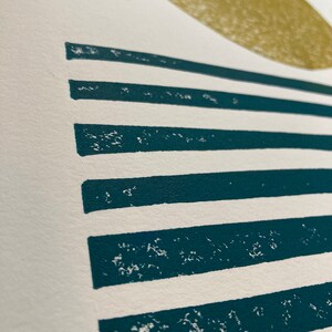 May include: Abstract art print with a large, off-white circle and horizontal teal stripes.