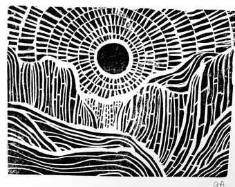 May include: Black and white linocut print of a stylized sun rising over a mountain range. The sun is a circle with a textured surface and the mountains are made up of repeating lines.