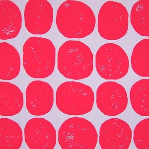 May include: A white background with a repeating pattern of bright pink circles. The circles are evenly spaced and overlap slightly.