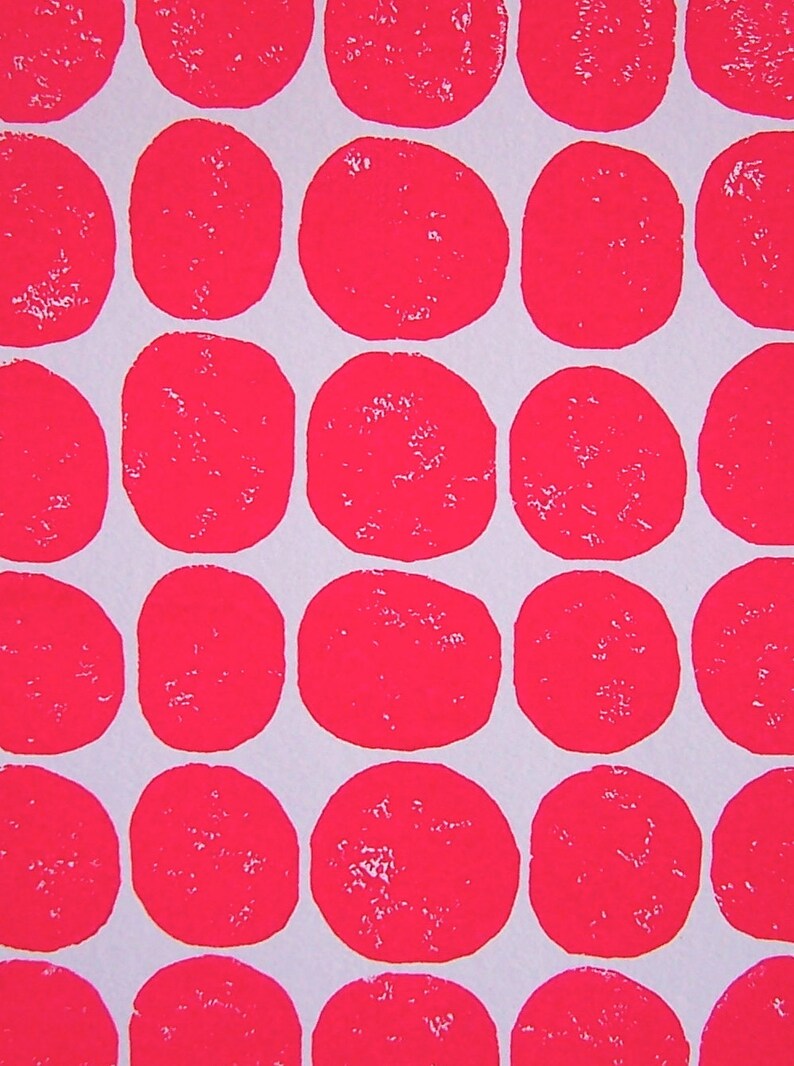 May include: A white background with a repeating pattern of bright pink circles. The circles are evenly spaced and overlap slightly.