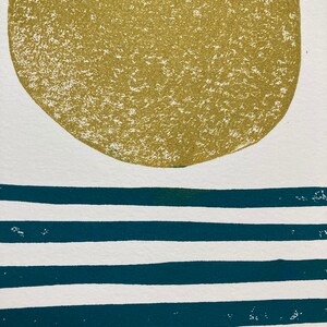 May include: A green circle on a white background with teal blue horizontal stripes.