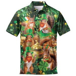 May include: Green polo shirt featuring a whimsical St. Patrick's Day design. The shirt showcases cartoon squirrels with red mustaches and beards, wearing green hats, surrounded by shamrocks, gold coins, and a pot of gold. The Irish flag is also visible.