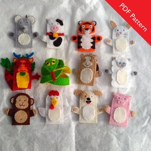 May include: A set of 12 felt finger puppets featuring various animals, including a cow, tiger, rabbit, dragon, snake, horse, monkey, chicken, dog, pig, mouse, and sheep. The puppets are all brightly colored and have friendly faces.