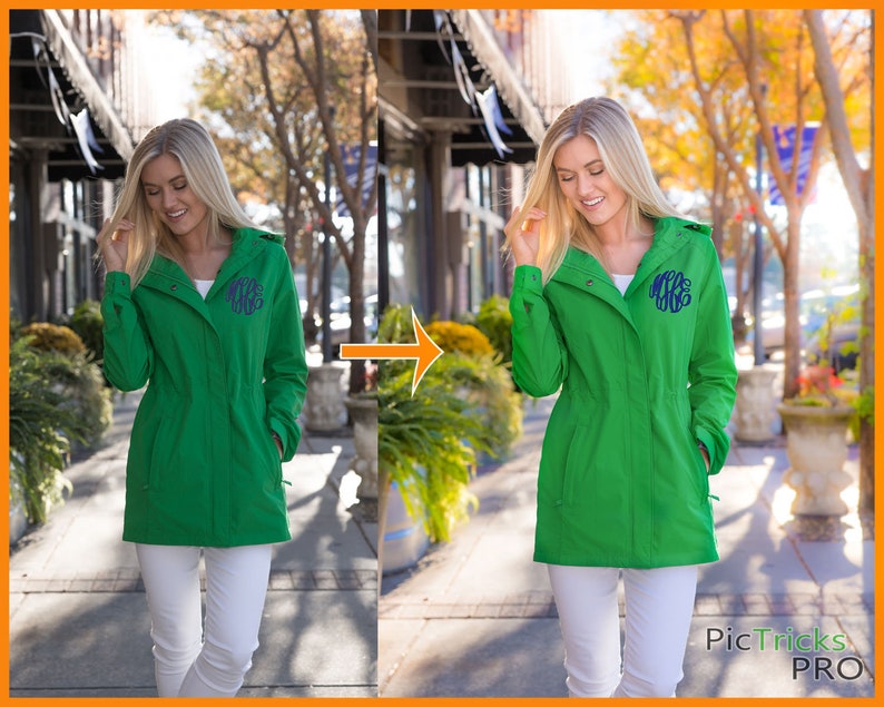 May include: A green hooded jacket with a white monogram on the front. The jacket is worn by a person standing on a sidewalk in front of a building.