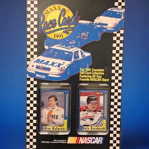 May include: A 1991 MAXX Race Cards box set featuring NASCAR stars. The box has a black background with blue car illustrations and the text "MAXX Race Cards 1991". Includes cards of Alan Kulwicki and Dale Earnhardt. Officially licensed NASCAR product.