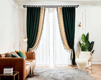May include: Dark green and beige velvet curtains with decorative tassels frame a bright window. The curtains are paired with sheer white panels. A brown leather sofa with colourful cushions and a gold chair with a white fur throw complete the room.