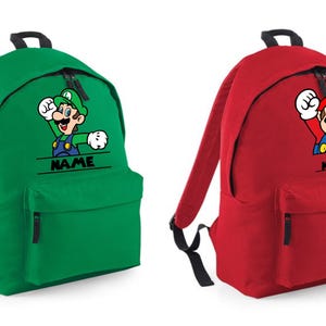 May include: Two backpacks, one green and one red, each featuring a cartoon character. The green backpack has a Luigi graphic, and the red backpack has a Mario graphic. Both backpacks have the word "NAME" printed below the character.