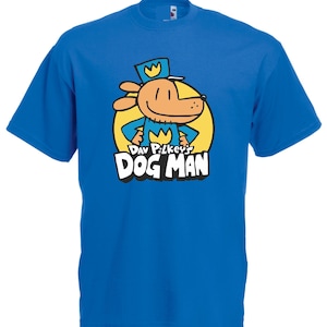 May include: A royal blue t-shirt featuring a cartoon illustration of Dog Man from Dav Pilkey's book series. The design includes a dog-like character in a police uniform, set against a yellow circle with the words "Dog Man".