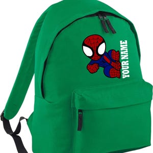 May include: Green backpack featuring a cartoon Spider-Man graphic in red, blue, and white. The backpack has a front pocket and the text "YOUR NAME" printed vertically in white. Includes black zippers and straps.