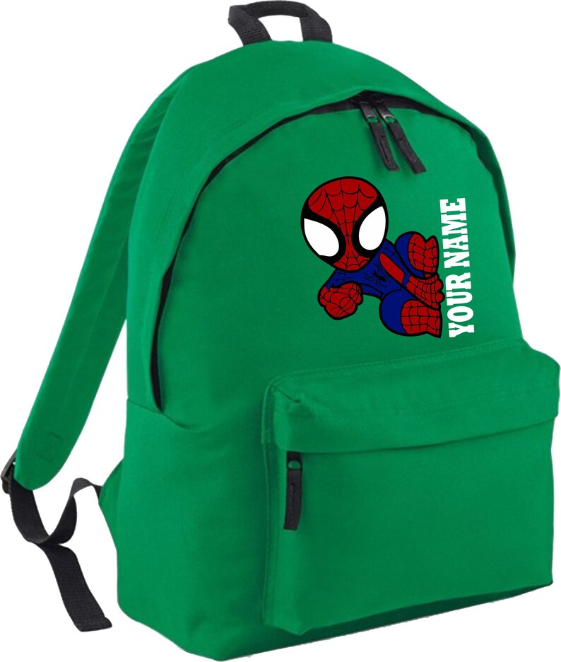 May include: Green backpack featuring a cartoon Spider-Man graphic in red, blue, and white. The backpack has a front pocket and the text "YOUR NAME" printed vertically in white. Includes black zippers and straps.