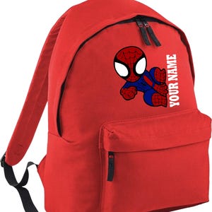May include: Red backpack featuring a cartoon Spider-Man graphic. The backpack has a front pocket, two black zippers, and adjustable straps. The text "YOUR NAME" is printed vertically on the side. Perfect for school or travel.