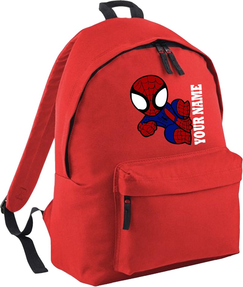 May include: Red backpack featuring a cartoon Spider-Man graphic. The backpack has a front pocket, two black zippers, and adjustable straps. The text "YOUR NAME" is printed vertically on the side. Perfect for school or travel.
