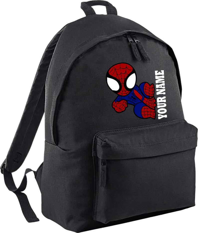 May include: Black backpack featuring a colorful cartoon Spider-Man graphic. The superhero is depicted in red and blue, with the text "YOUR NAME" printed vertically in white on the side. The backpack has a front pocket and two zippered compartments.