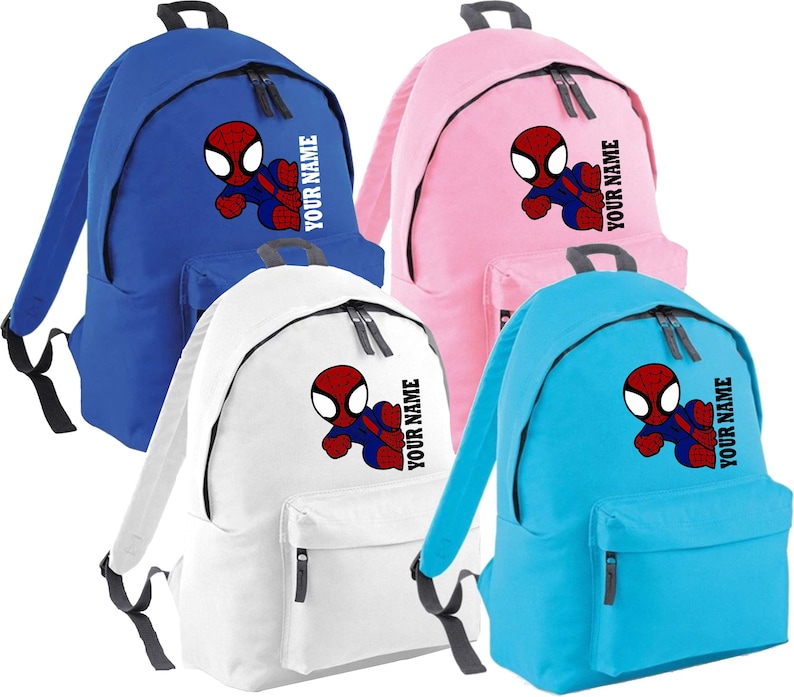 May include: Four backpacks in blue, pink, white, and light blue. Each backpack features a Spider-Man graphic and the text "YOUR NAME". The backpacks have a front pocket and black zippers.