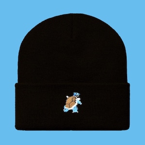 May include: Black beanie with a small embroidered image of a blue and brown turtle.